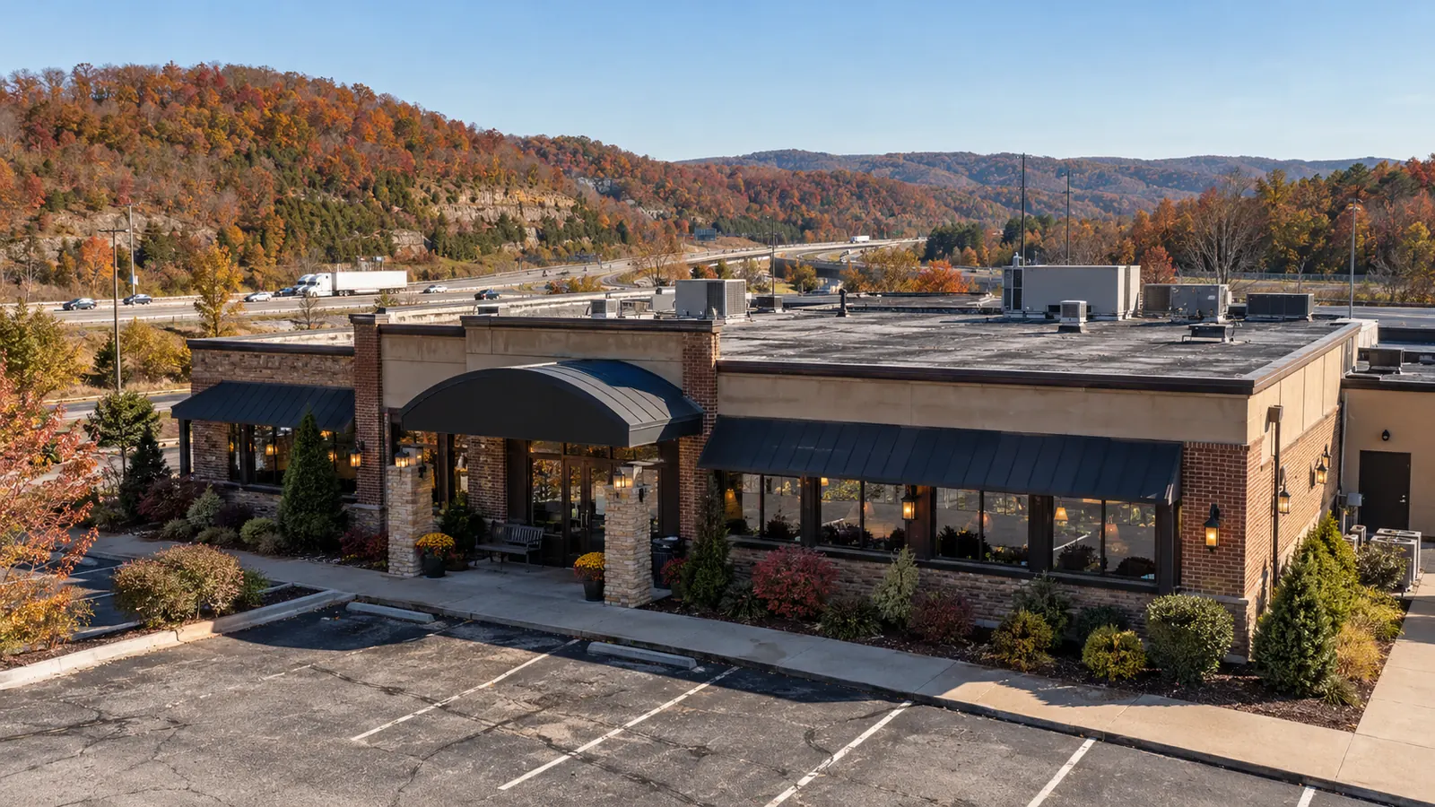 Commercial building with shingle and flat roof sections